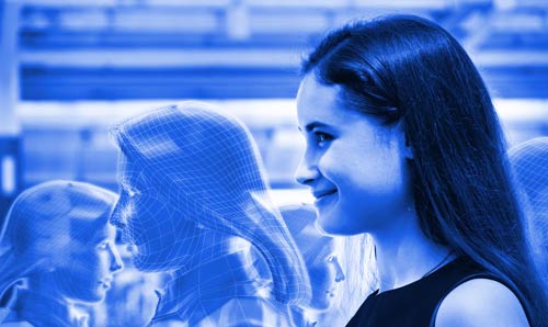A side view of a woman interacting with a transparent digital interface, set against a blue-themed background, symbolising modern technology and digital communication