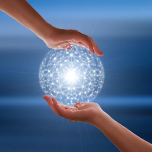 image of hands holding a glowing ball of computer networks.